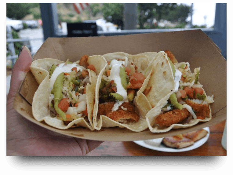 A close up of three tacos on a plate