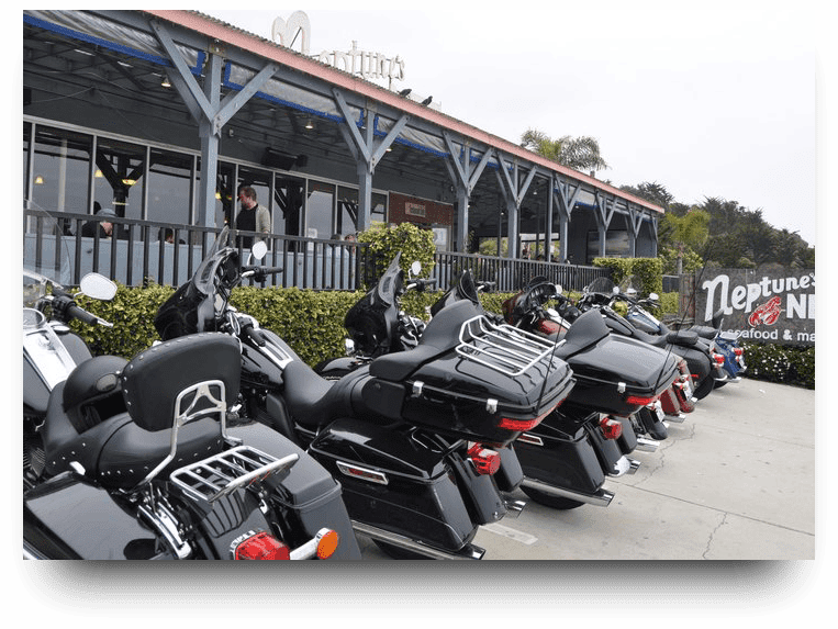 A row of motorcycles parked in front of a building.
